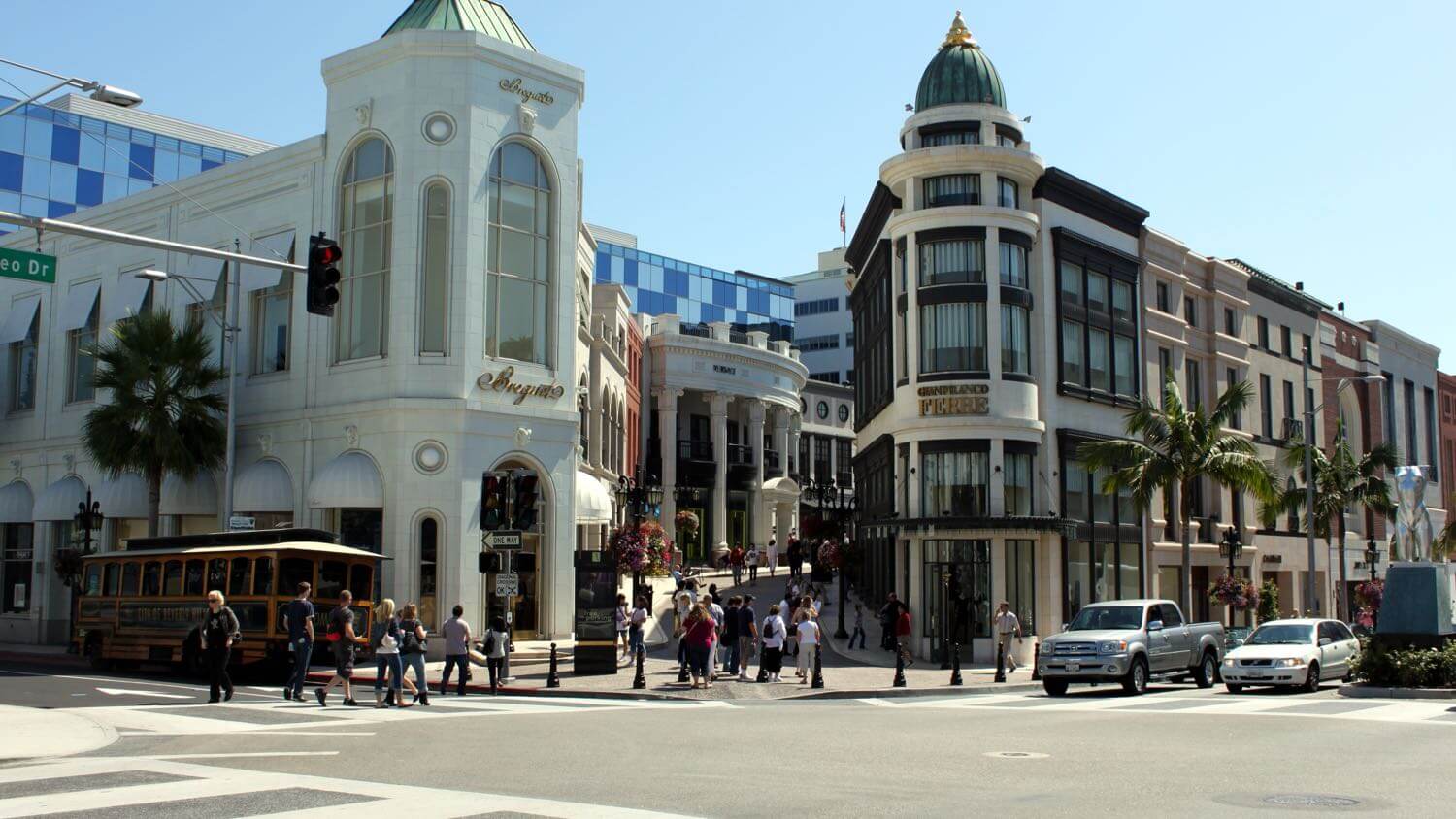 The luxury storefronts of Rodeo Drive in Beverly Hills with palm trees and a trolley — EMF radiation testing and shielding help for Beverly Hills homes