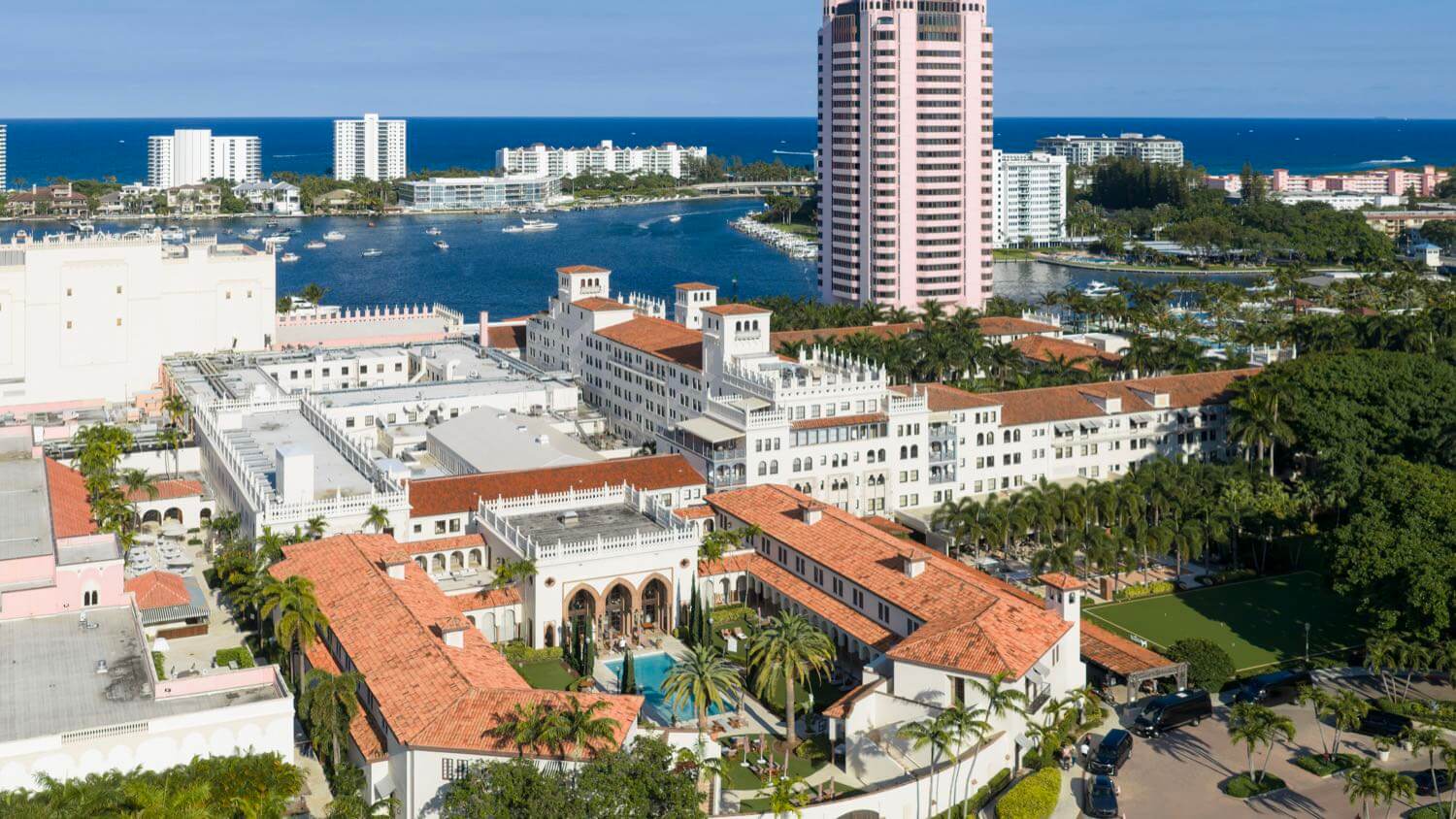 The historic pink Boca Raton Resort & Club with red-tile roofs and the Intracoastal behind, Boca Raton, Florida — EMF radiation testing and shielding help for Boca Raton homes