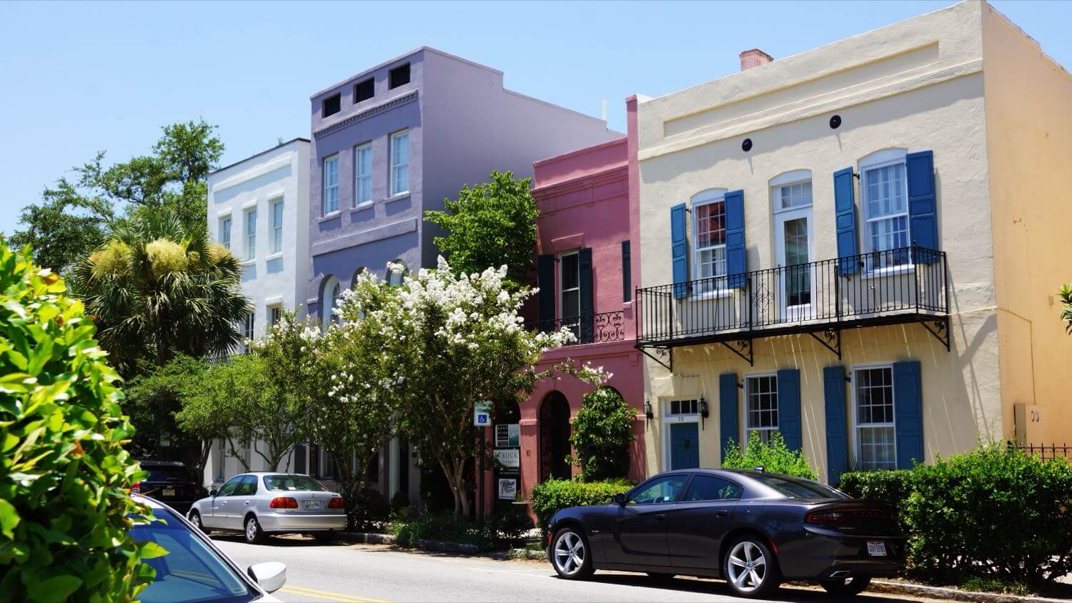 The pastel historic houses of Rainbow Row in Charleston, South Carolina, with wrought-iron balconies — EMF radiation testing and shielding help for Charleston homes