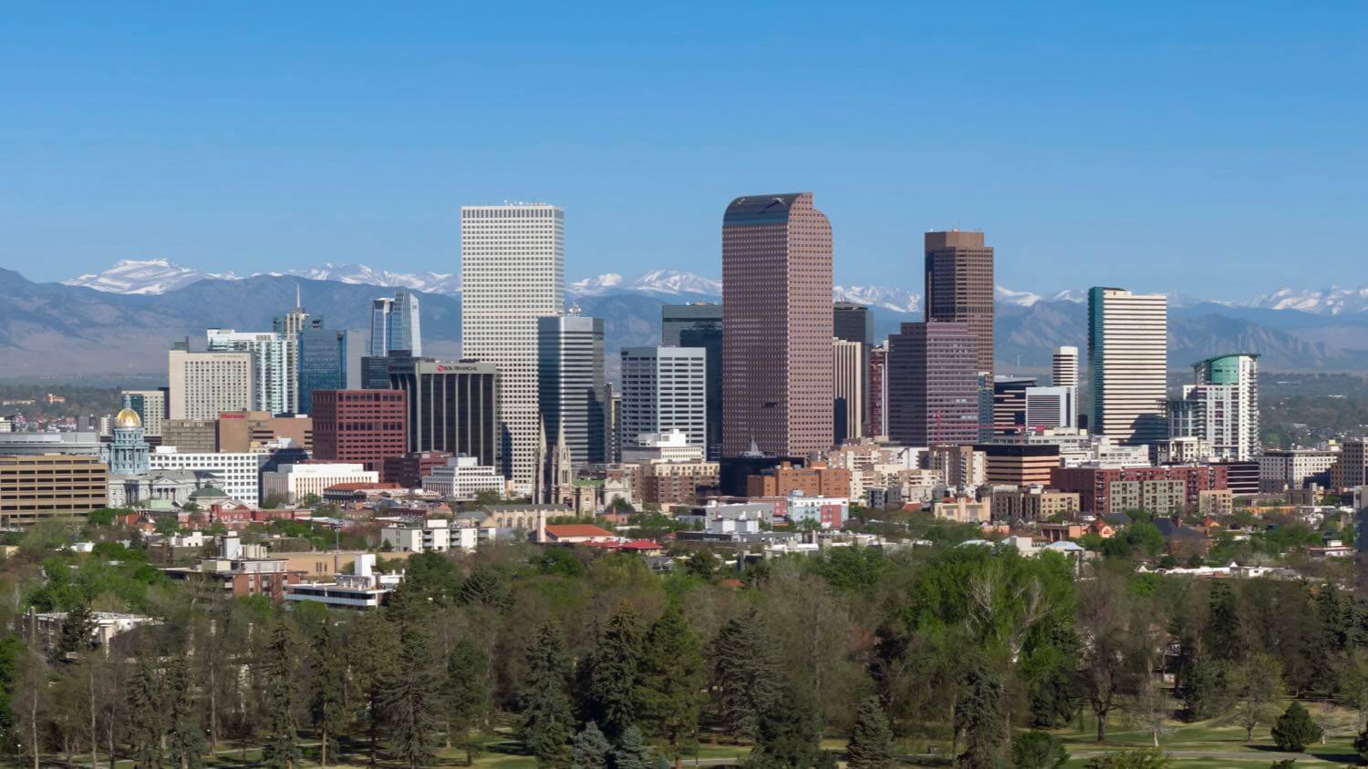 Downtown Denver, Colorado skyline with the Rocky Mountains beyond &mdash; EMF radiation testing and shielding help for Denver homes