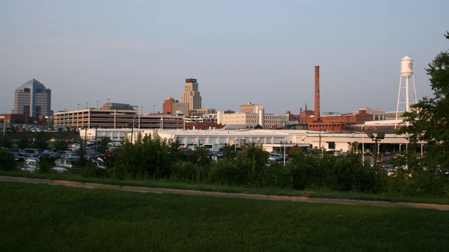 Downtown Durham, North Carolina skyline with the historic Lucky Strike water tower and an old tobacco-factory smokestack — EMF radiation testing and shielding help for Durham homes