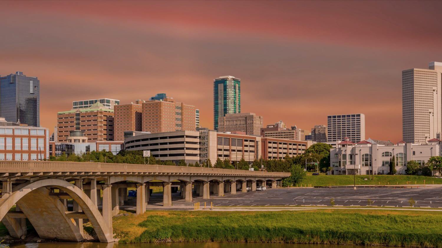 Downtown Fort Worth, Texas skyline at golden hour over the Trinity River and an arched bridge — EMF radiation testing and shielding help for Fort Worth homes