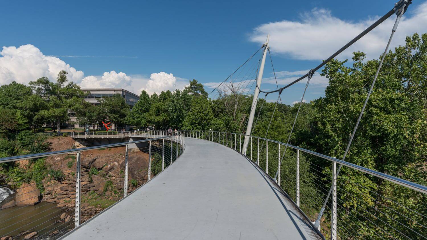 The curved Liberty Bridge over Falls Park on the Reedy River in downtown Greenville, South Carolina &mdash; EMF radiation testing and shielding help for Greenville homes