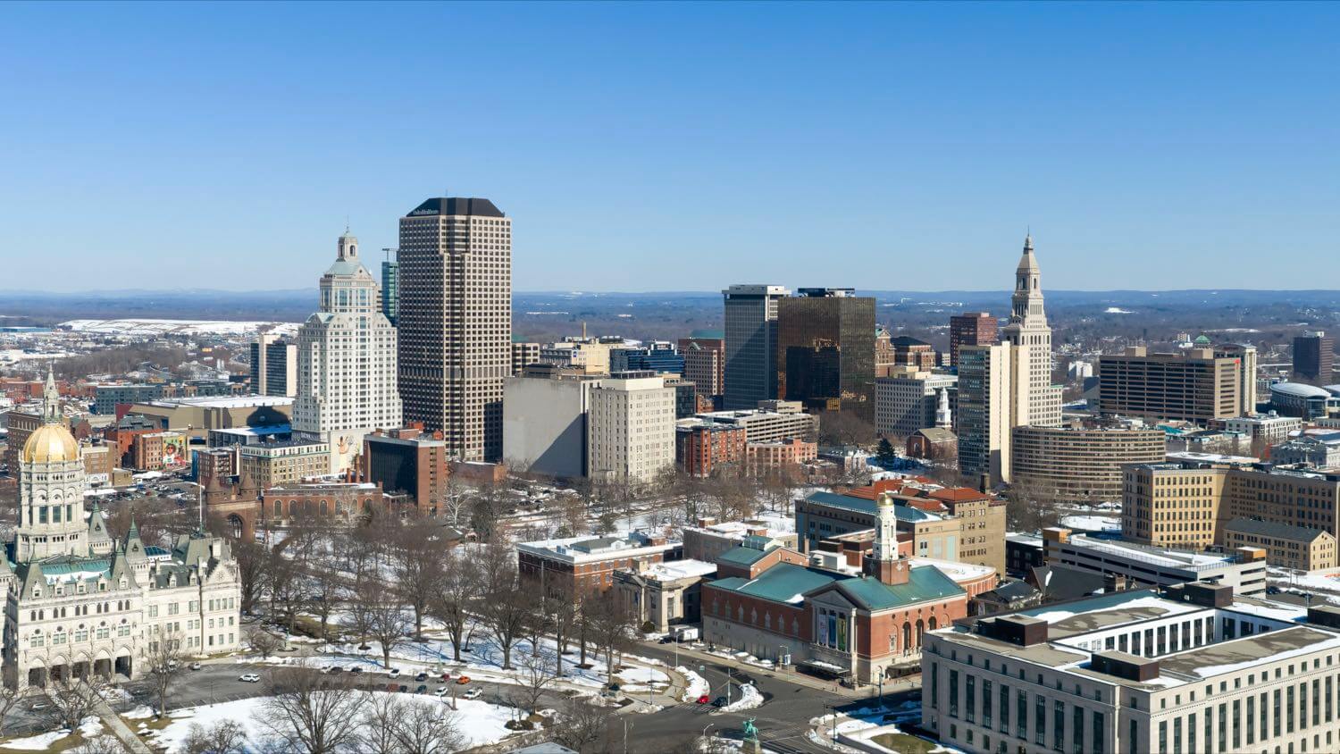 The downtown Hartford, Connecticut skyline with the Travelers Tower and the gold-domed State Capitol in winter &mdash; EMF radiation testing and shielding help for Hartford homes
