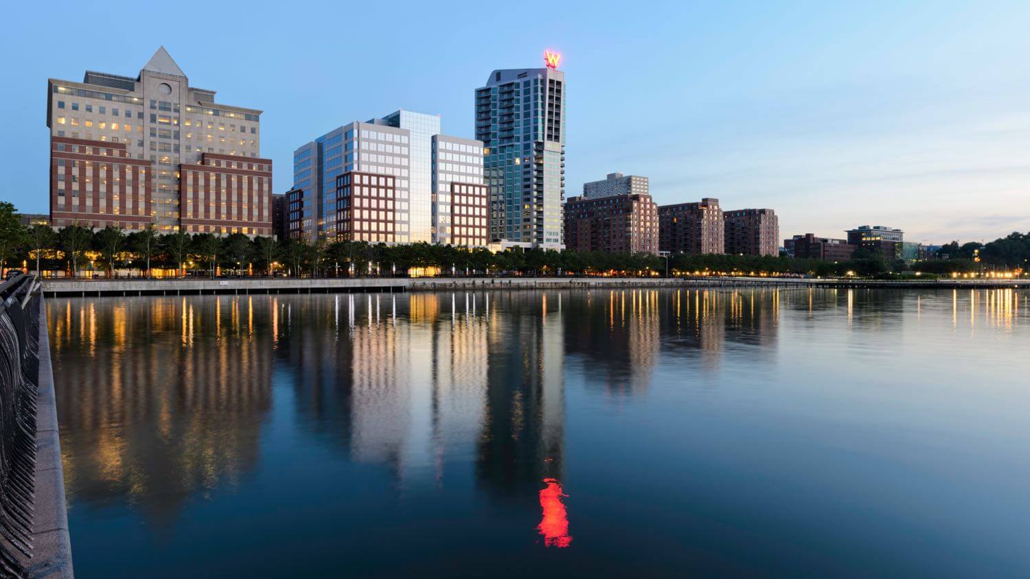 Hoboken, New Jersey waterfront at dusk with Pier A Park and the W Hotel reflected on the Hudson &mdash; EMF radiation testing and shielding help for Hoboken homes