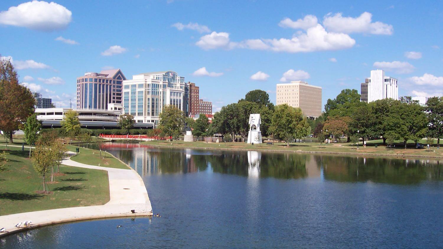 Downtown Huntsville, Alabama reflected in the lake at Big Spring Park &mdash; EMF radiation testing and shielding help for Huntsville homes