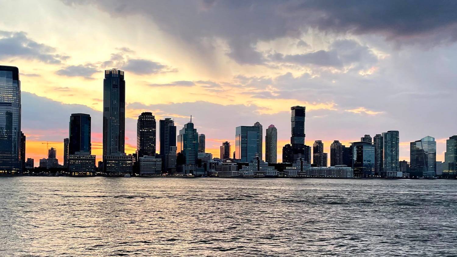 Jersey City, New Jersey waterfront skyline at golden hour with the Goldman Sachs Tower across the Hudson — EMF radiation testing and shielding help for Jersey City homes