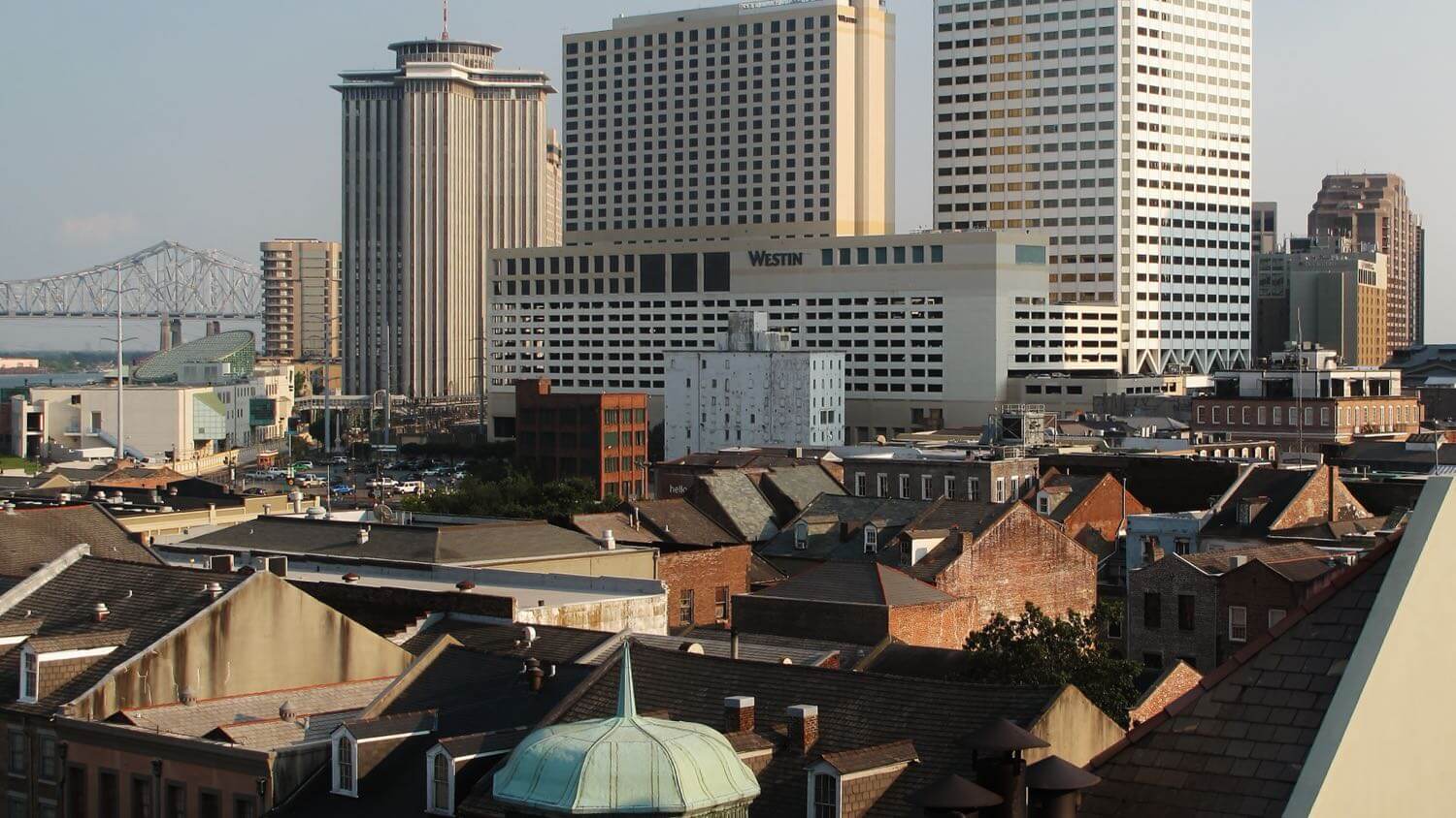 The downtown New Orleans skyline rising above the historic French Quarter rooftops — EMF radiation testing and shielding help for New Orleans homes