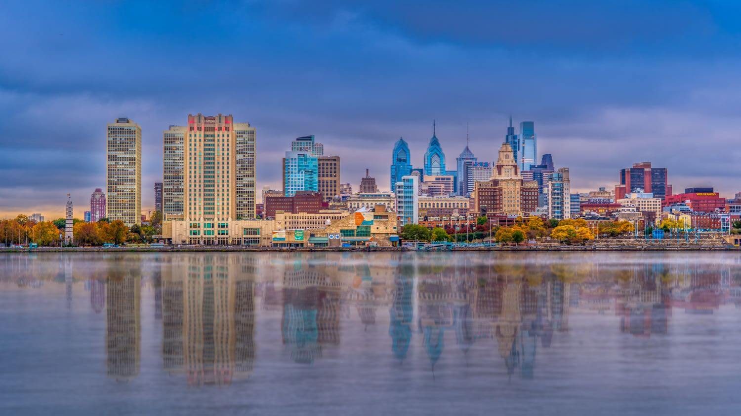 Philadelphia, Pennsylvania skyline beyond rows of brick rowhouses — EMF radiation testing and shielding help for Philadelphia homes