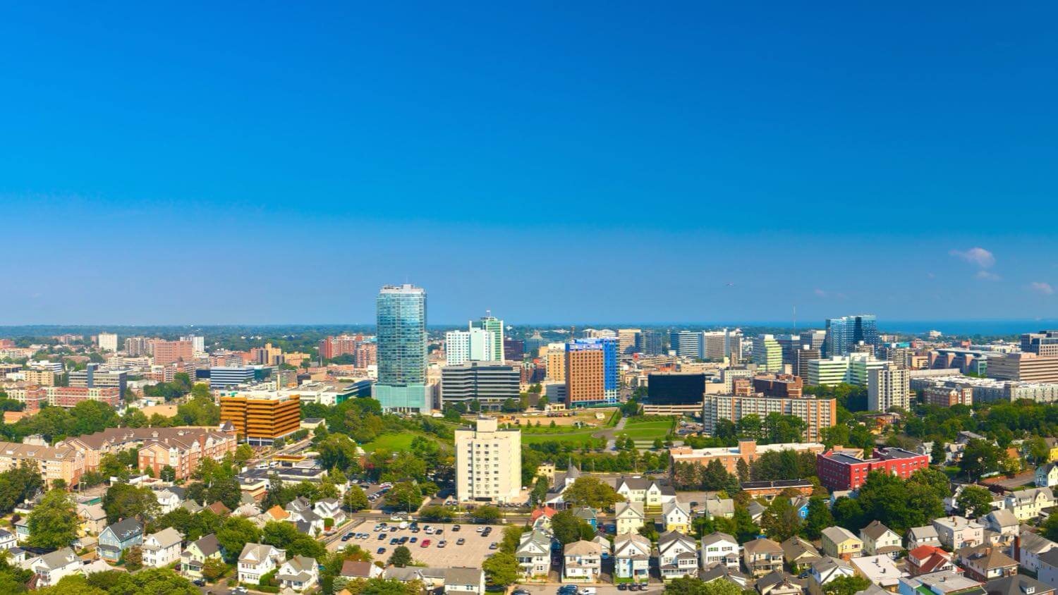 Downtown Stamford, Connecticut skyline with residential neighborhoods in the foreground &mdash; EMF radiation testing and shielding help for Stamford homes