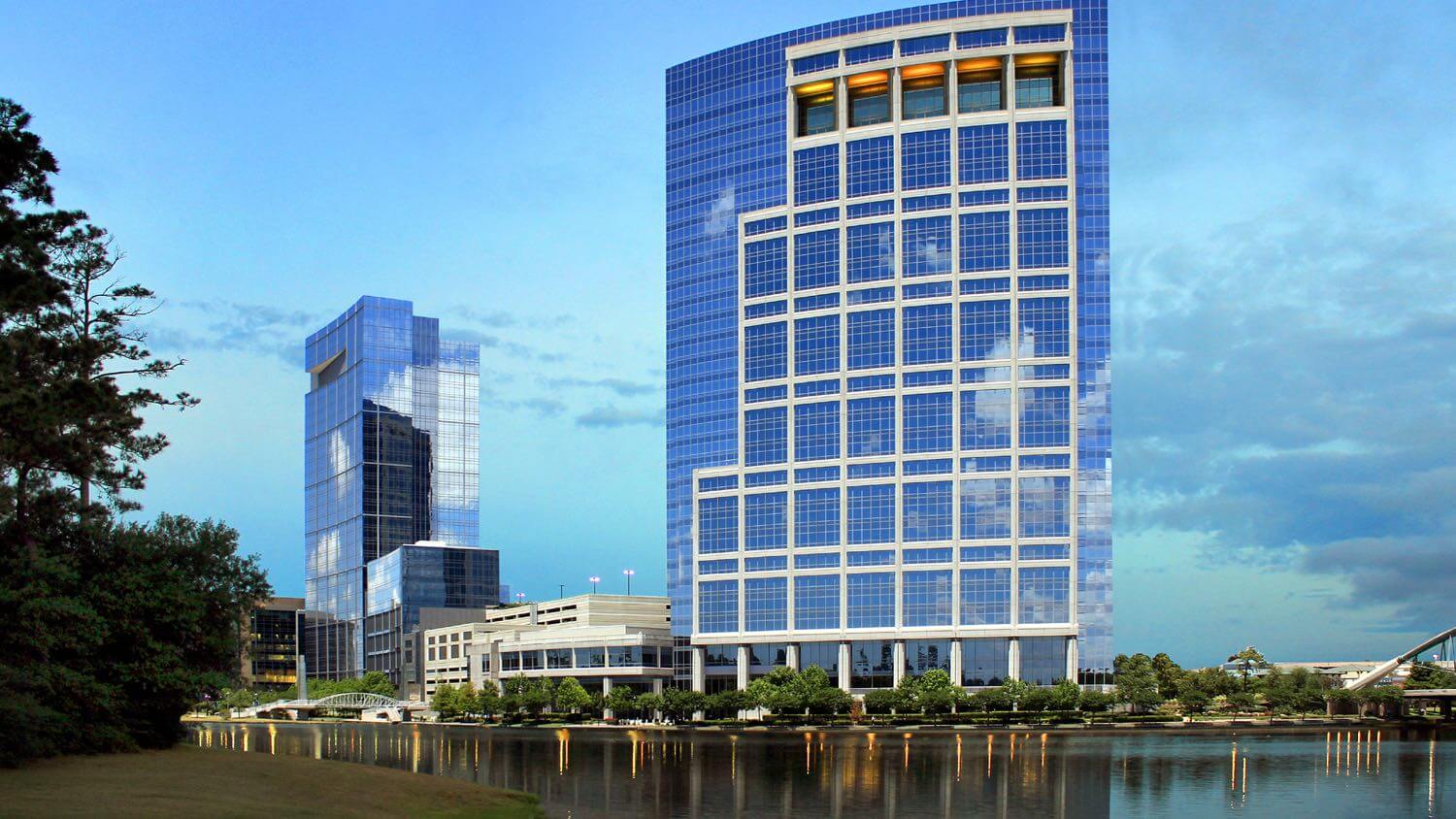 The twin glass towers reflected in The Woodlands Waterway at Town Center &mdash; EMF radiation testing and shielding help for The Woodlands, Texas homes