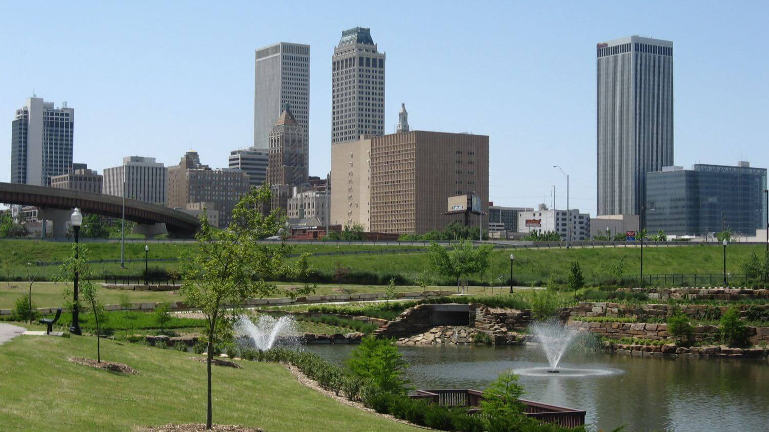 Downtown Tulsa, Oklahoma skyline beyond a park with fountains &mdash; EMF radiation testing and shielding help for Tulsa homes